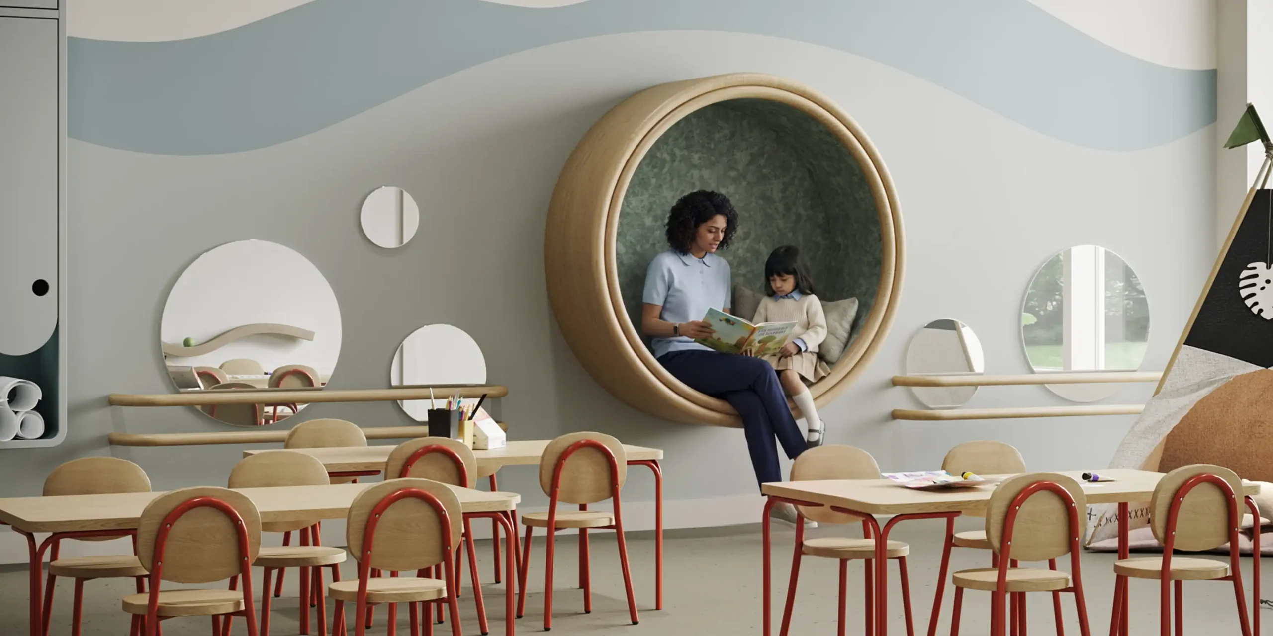 An educator and a child reading together in a rounded alcove at the Kinder Roots Redbridge academy